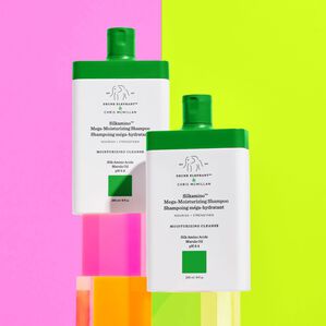 Image of two Silkamino Shampoos standing up right on top of blocks 