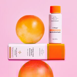 Image of C-Firma Fresh bottles standing on top of each other next to and on top of orange balls.