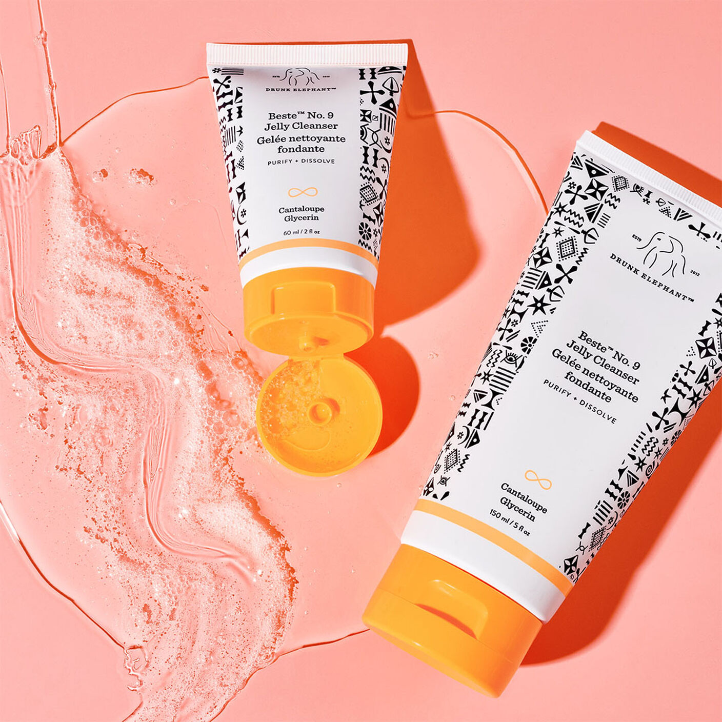  Beste No. 9 Jelly Cleanser standard size and midi sized on top of cleasner poured out onto a coral table.
