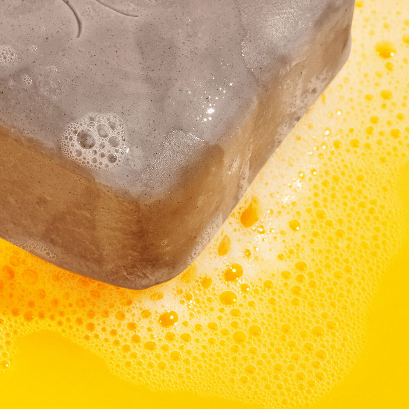 Lathered Juju Bar on a yellow table. 