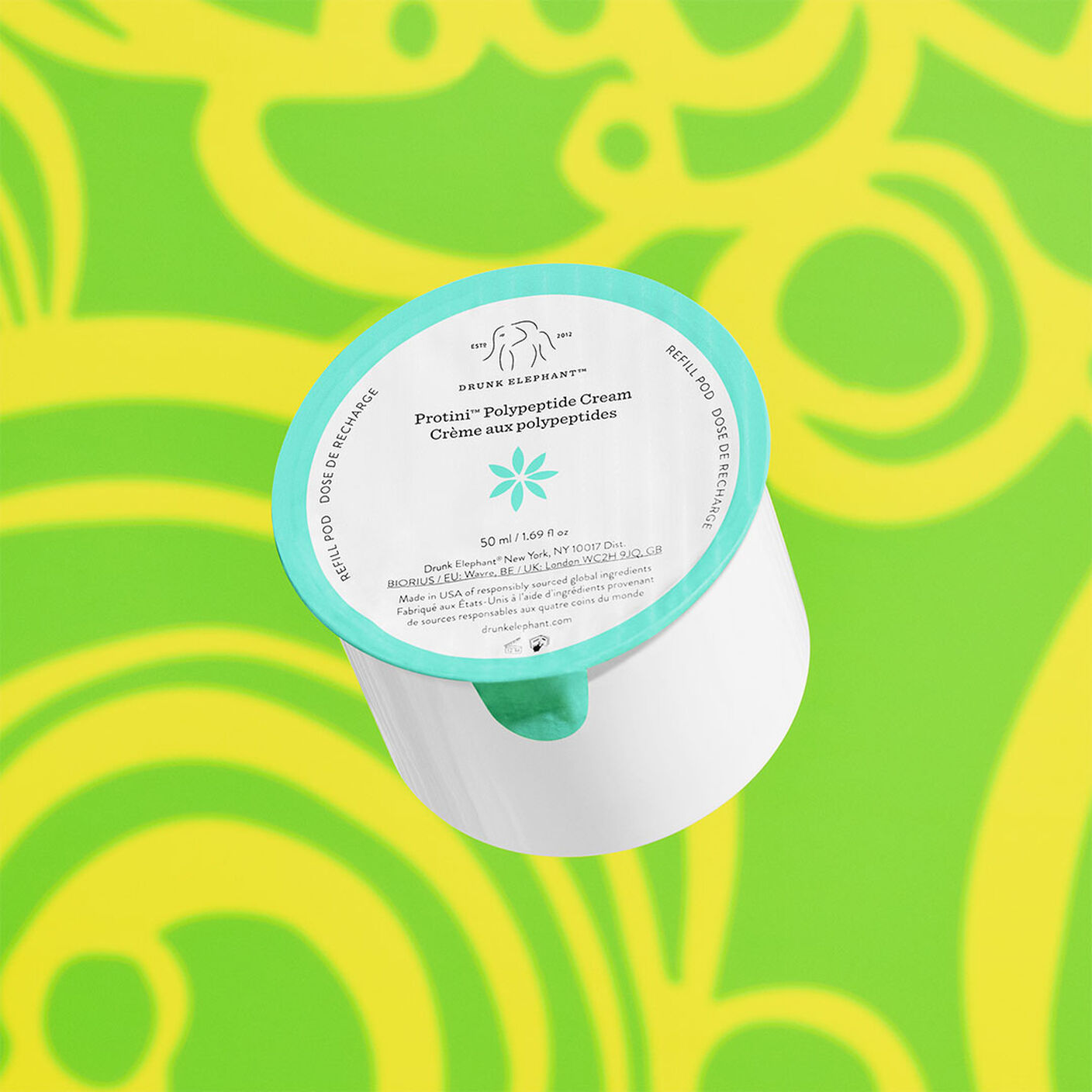 Protini Cream refill behind a green and yellow background. 