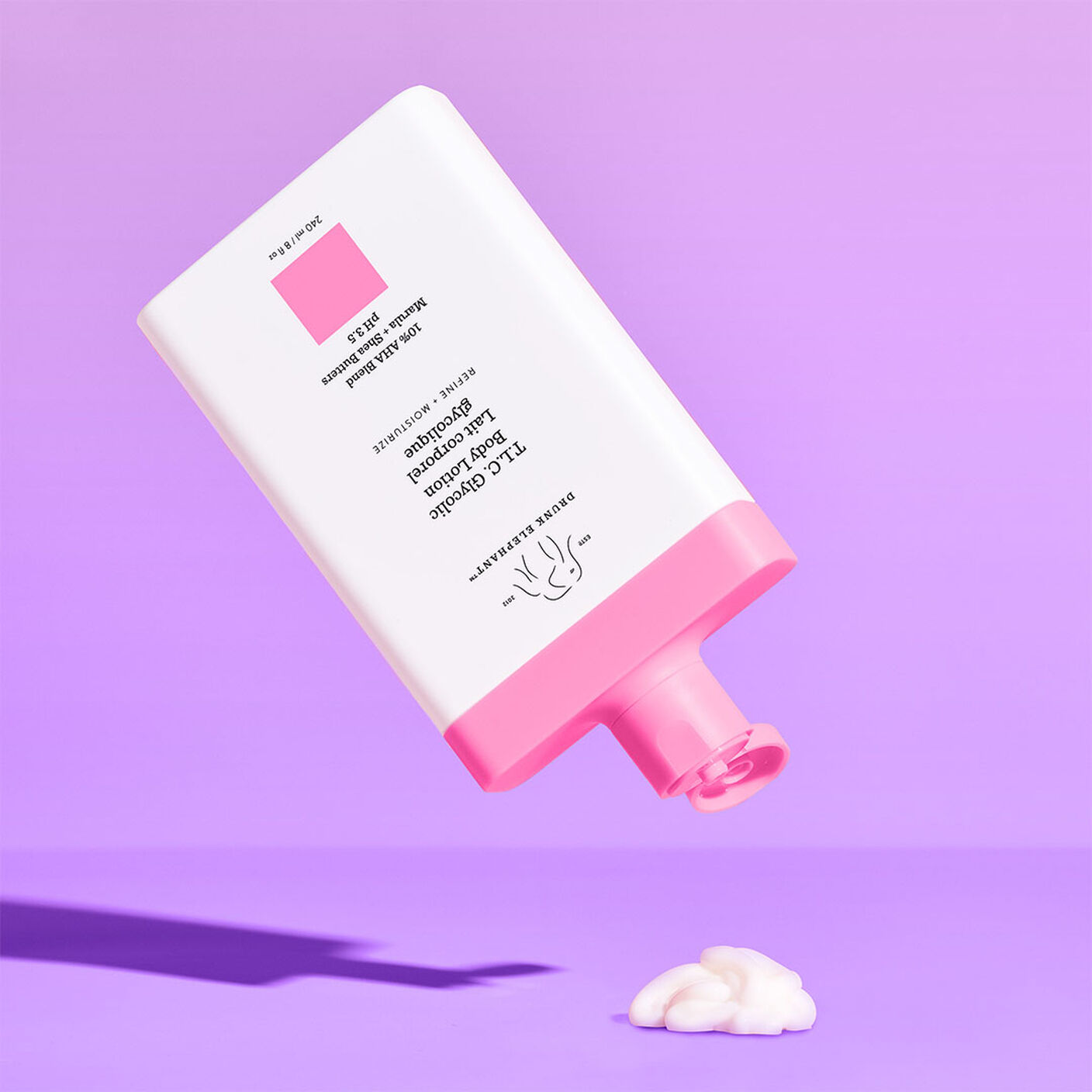 T.L.C Glycolic Body Lotion being poured out onto a purple table. 