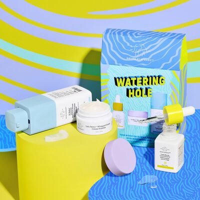 B-Hydra, Lala Retro, and Virgin Marula Oil next to Watering Hole kit with their cap opened and next to product texture