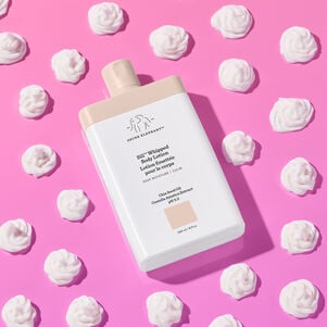 Sili Whipped bottle facing flat, surrounded by a dab of product swatches