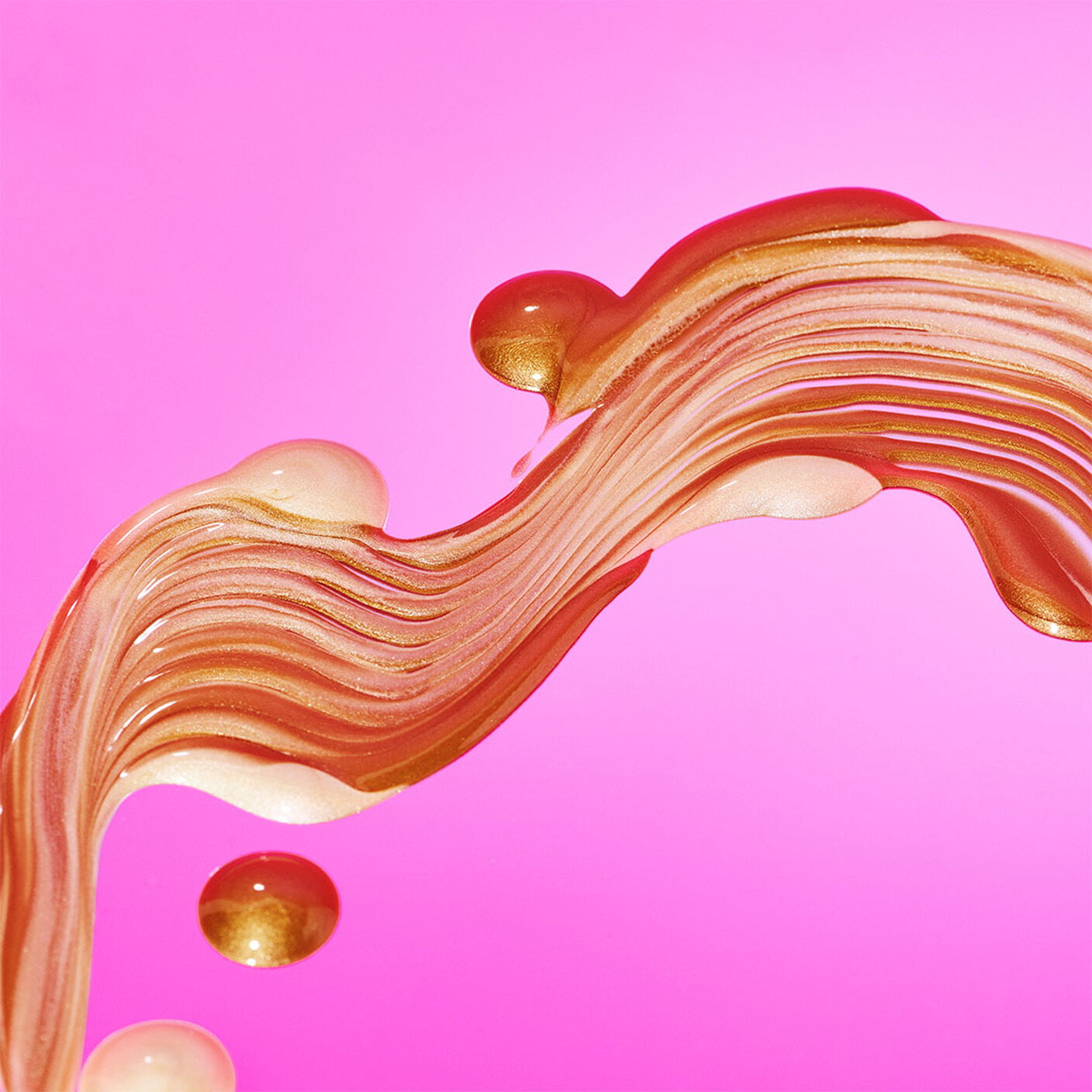 B-Goldi and D-Bronzi mixed smeared across a pink background. 