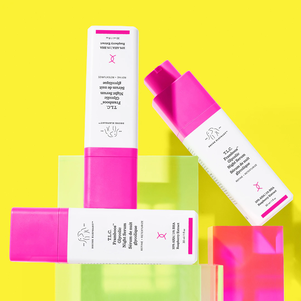 photo of two open TLC Framboos bottles displayed on a dark pink background