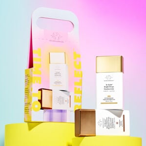 B-Goldi, D-bronzi and packaged Kit sitting on pink props behind a pink background.