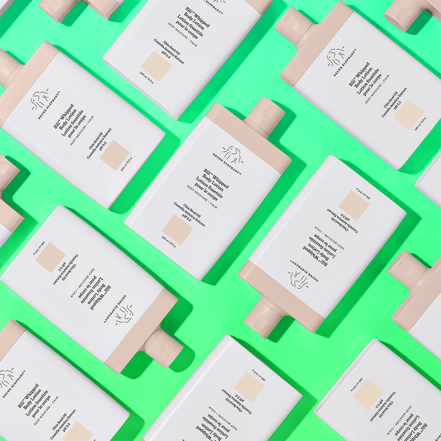 Multiple Sili Whipped Body Lotion Bottle on a green table. 