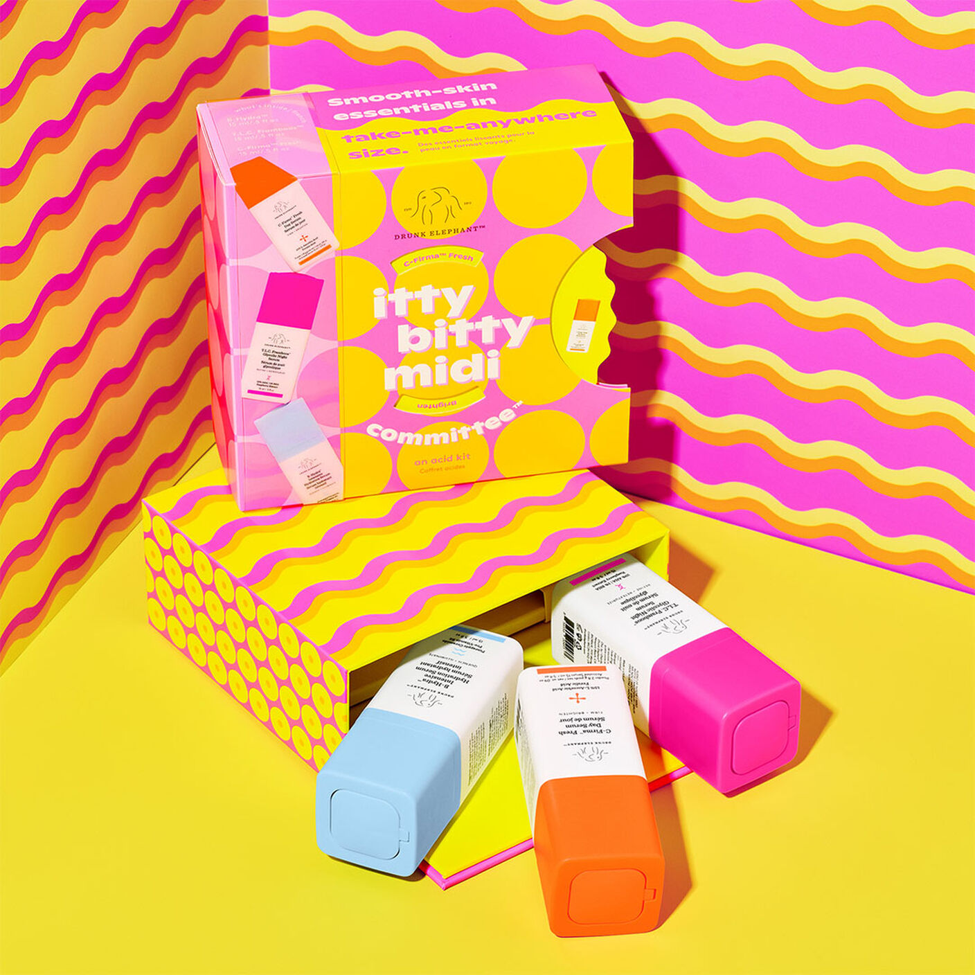 Products pouring out of packaing on a yellow table and pink and yellow wavey backgound.