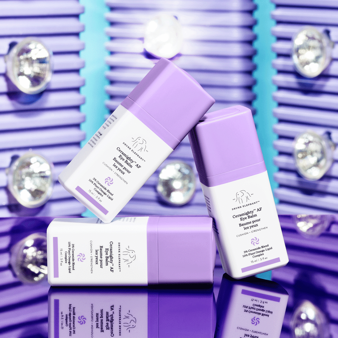 GIF of three Creamighty AF Eye Balm bottles on top of each other with flashing lights in the background. 