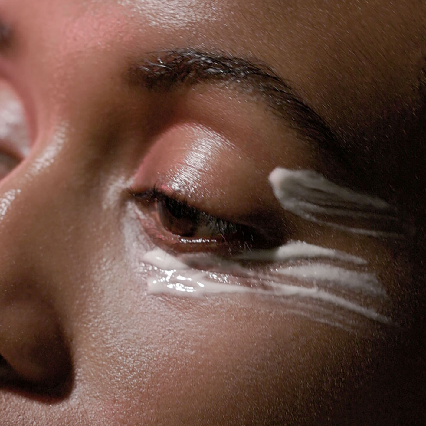A womans eye and cheek area with A-Shaba Complex Eye Serum applied underneath the eye and side of eye area. 