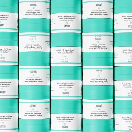 photo of Protini containers stacked on top of each other in columns