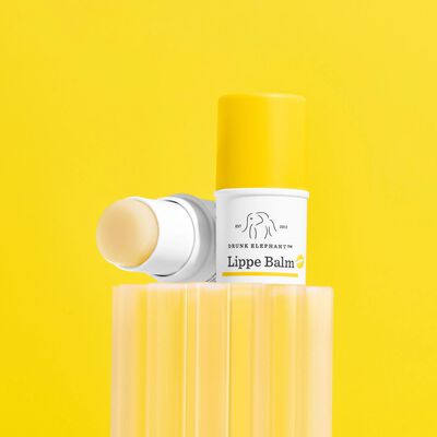 Three Lippe Balms against a yellow background and lips