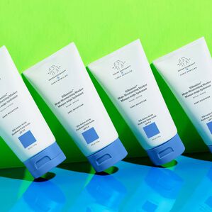 Multiple bottles of Silkamino Mega-Moisturizing Masker angled, leaning against a neon background
