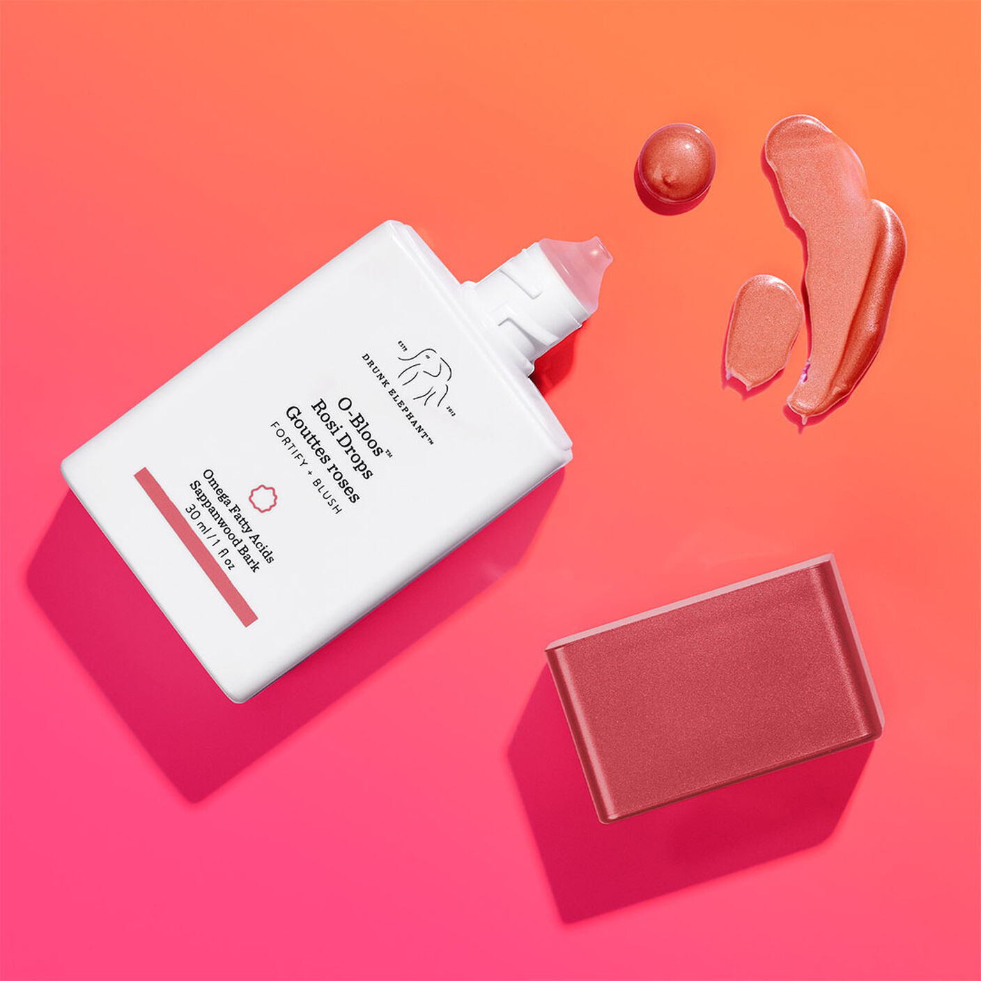 O-bloos with the cap off with a goop of serum next to it on a pink and orange background.