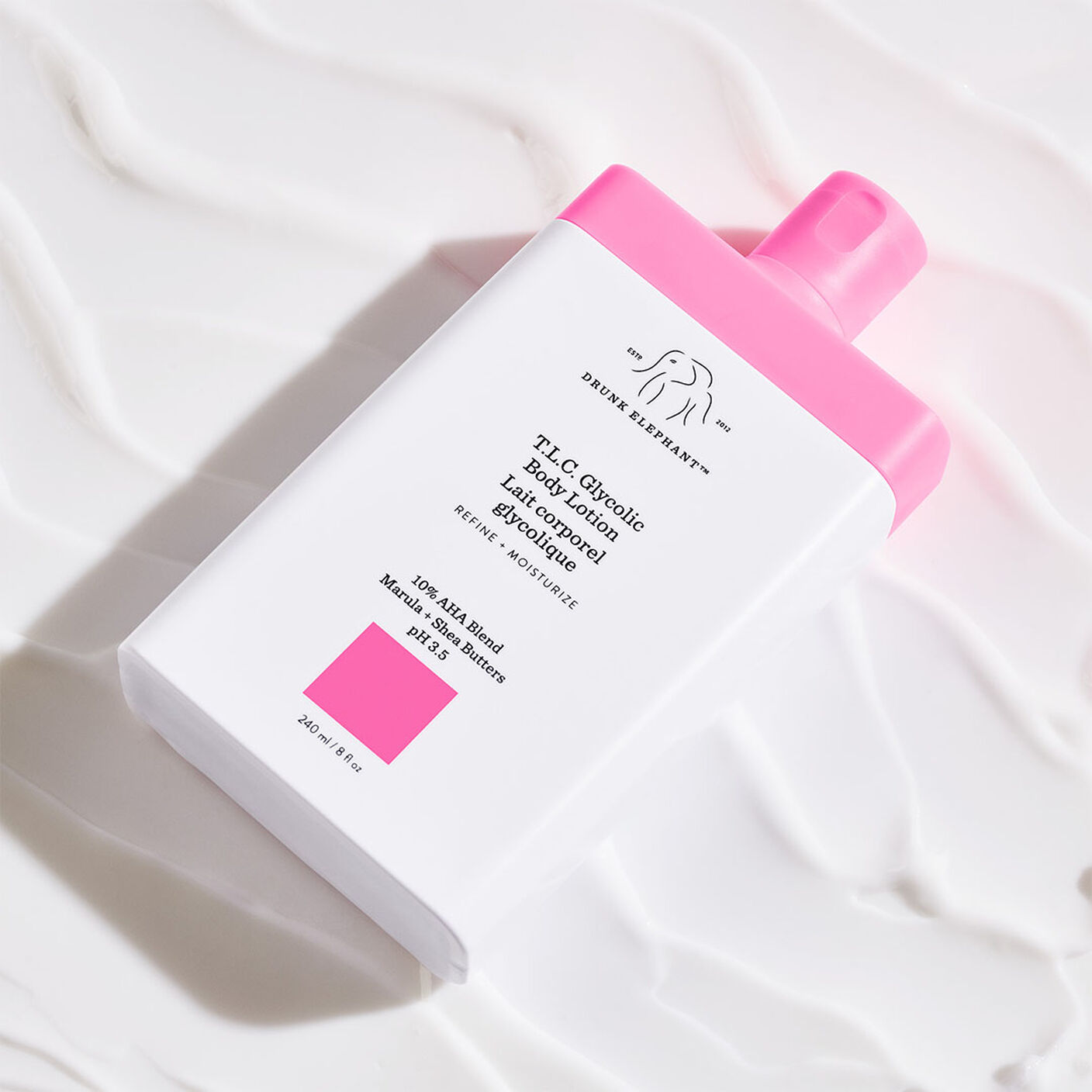 T.L.C Glycolic Body Lotion on top of a table covered in lotion.