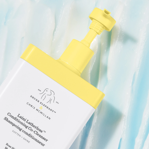 photograph of Laini Latherless™ Conditioning Co-Cleanser bottle and texture on blue background