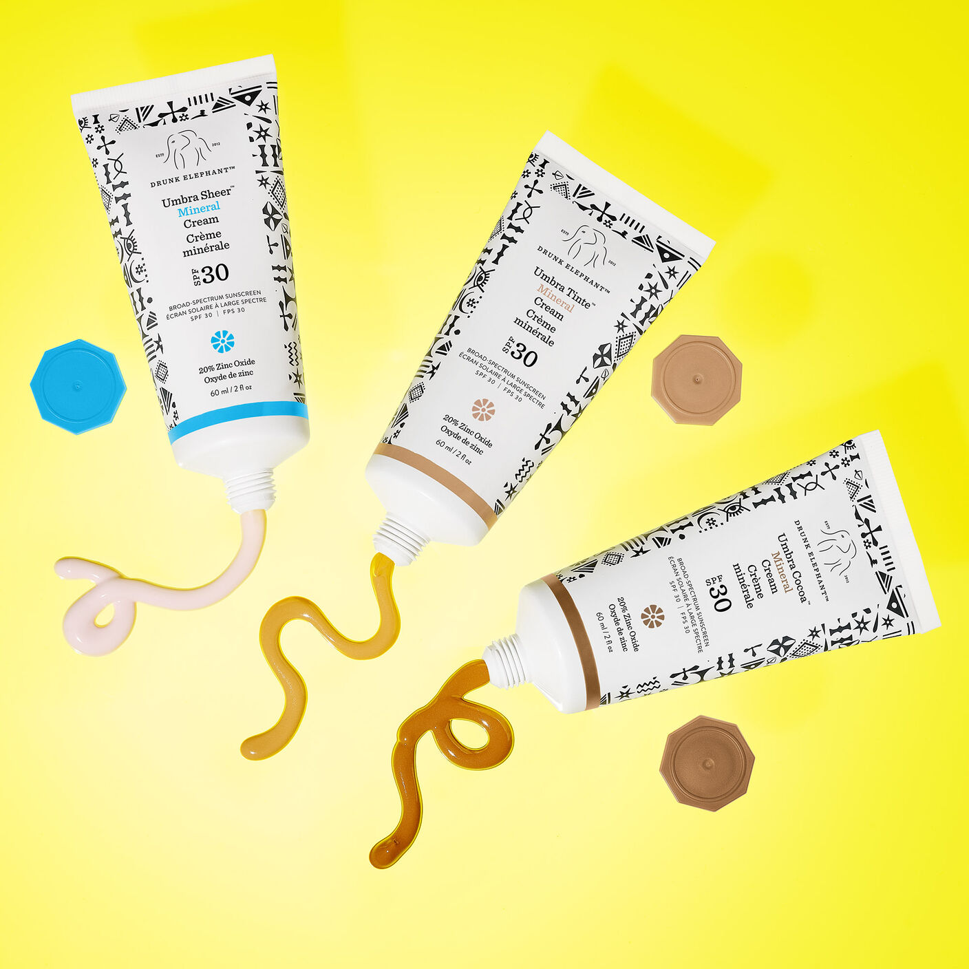 Umbra Sheer, Umbra Cocoa, and Umbra on a yellow background with some product squeezed out. 