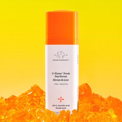 Image of a C-Firma Fresh bottle in front of a yellow background on top of orange rocks