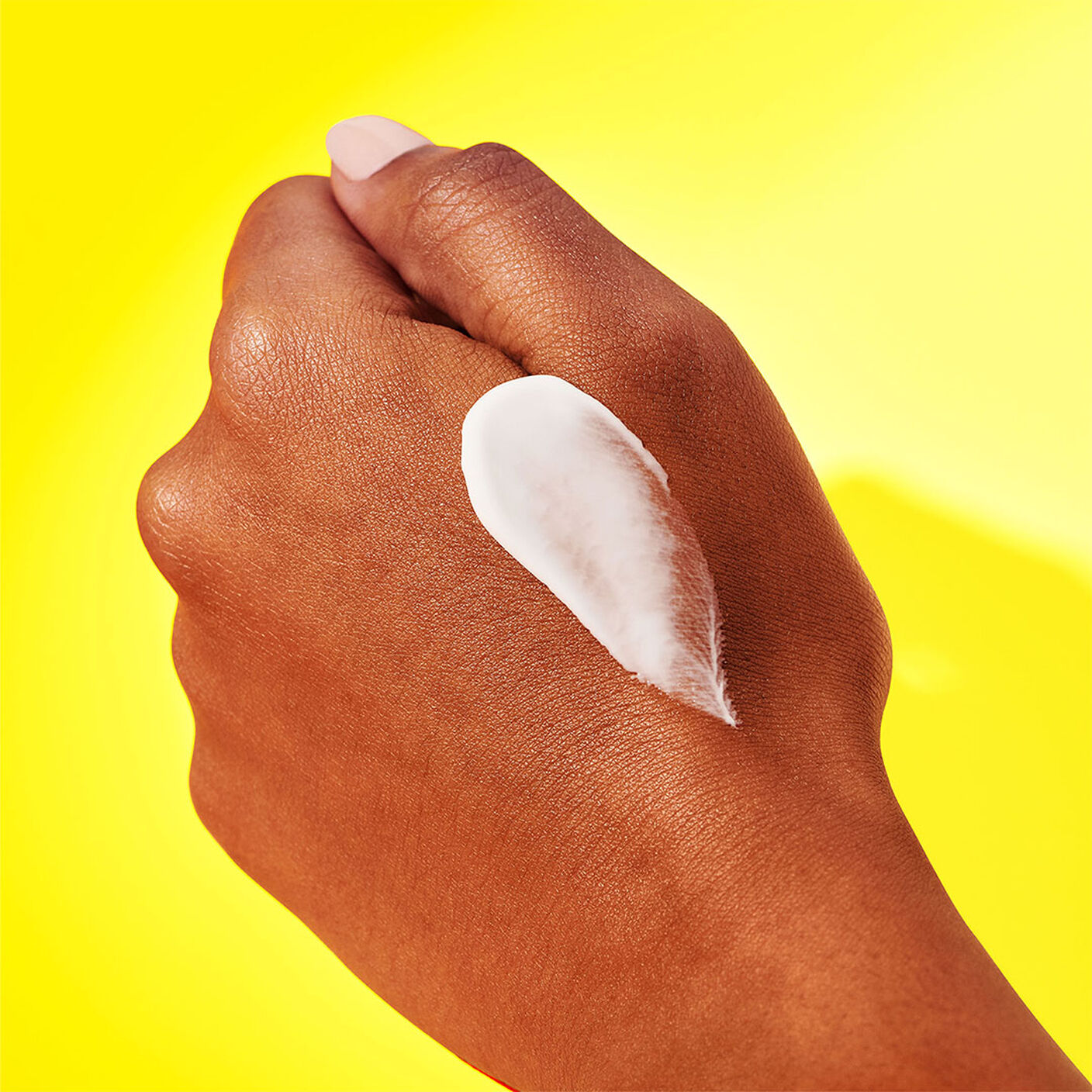Texture shot of Bouncy Brightfacial smear on the back of a hand. 