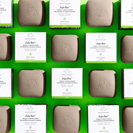 photo of Juju bars and their packaging arranged in a grid pattern against a bright green background