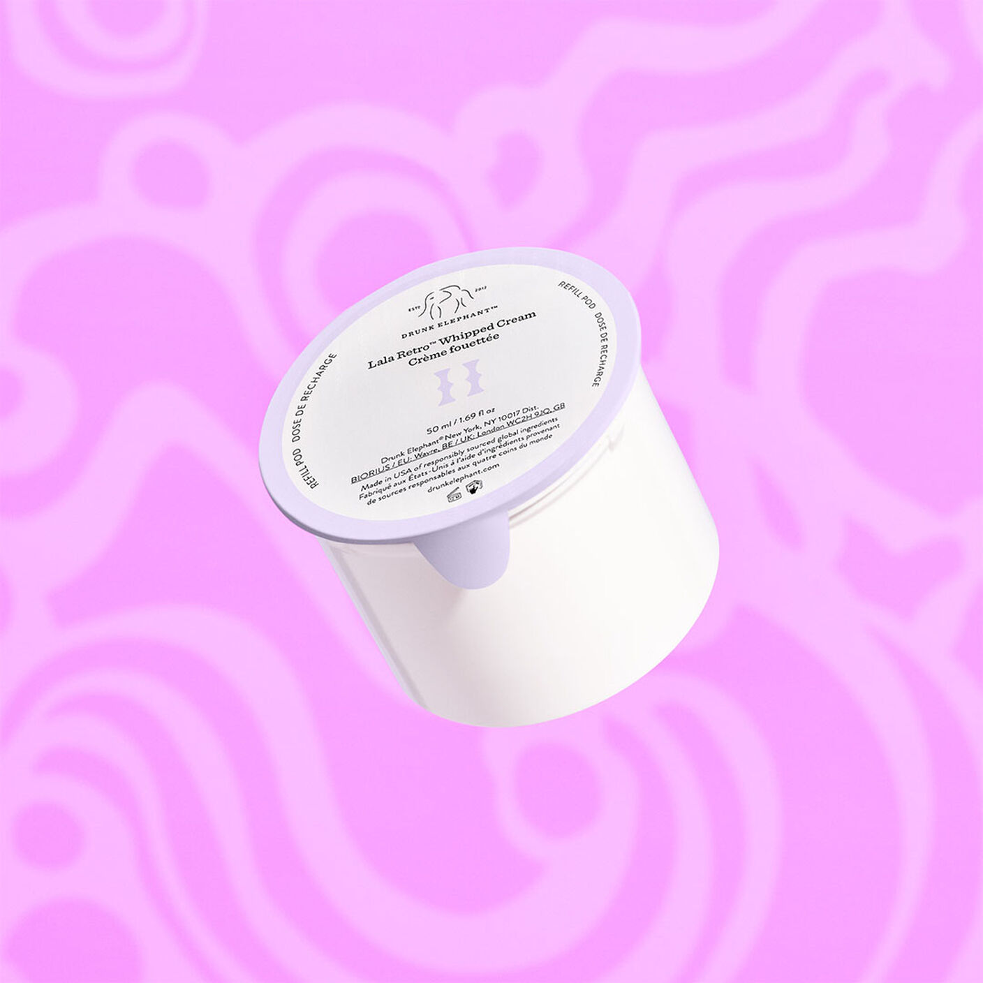 Lala Retro Cream refill behind a purple background. 