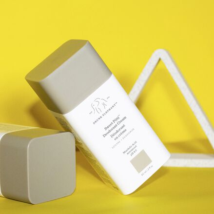 photo of two Sweet Pitti deodorant cream bottles against a yellow background