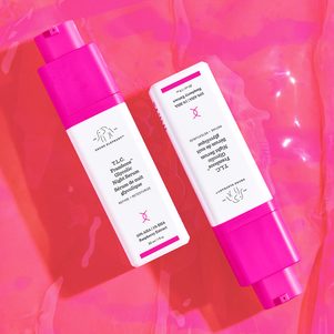 photo of several TLC Framboos bottles arrayed on a dark pink background