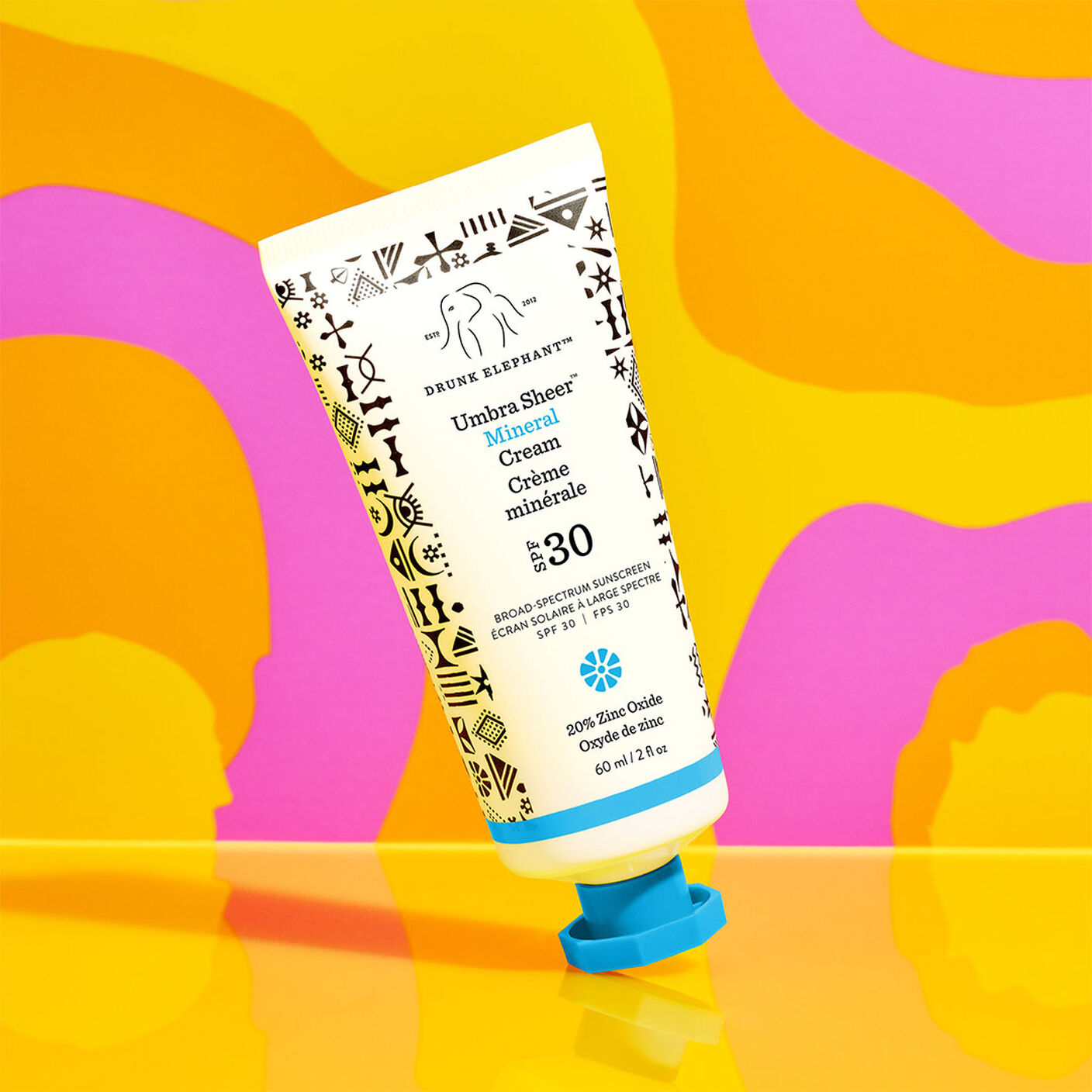 Umbra Sheer Mineral Cream against a pink and orange swirly background.