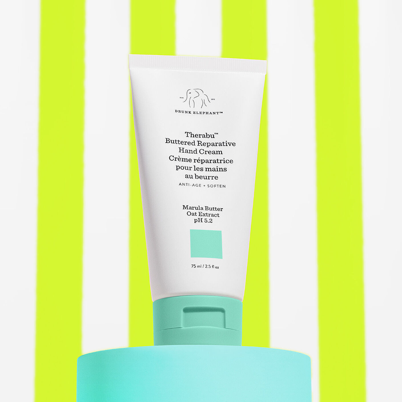 Therabu hand cream on a teal platform with a lime green and white striped background. 