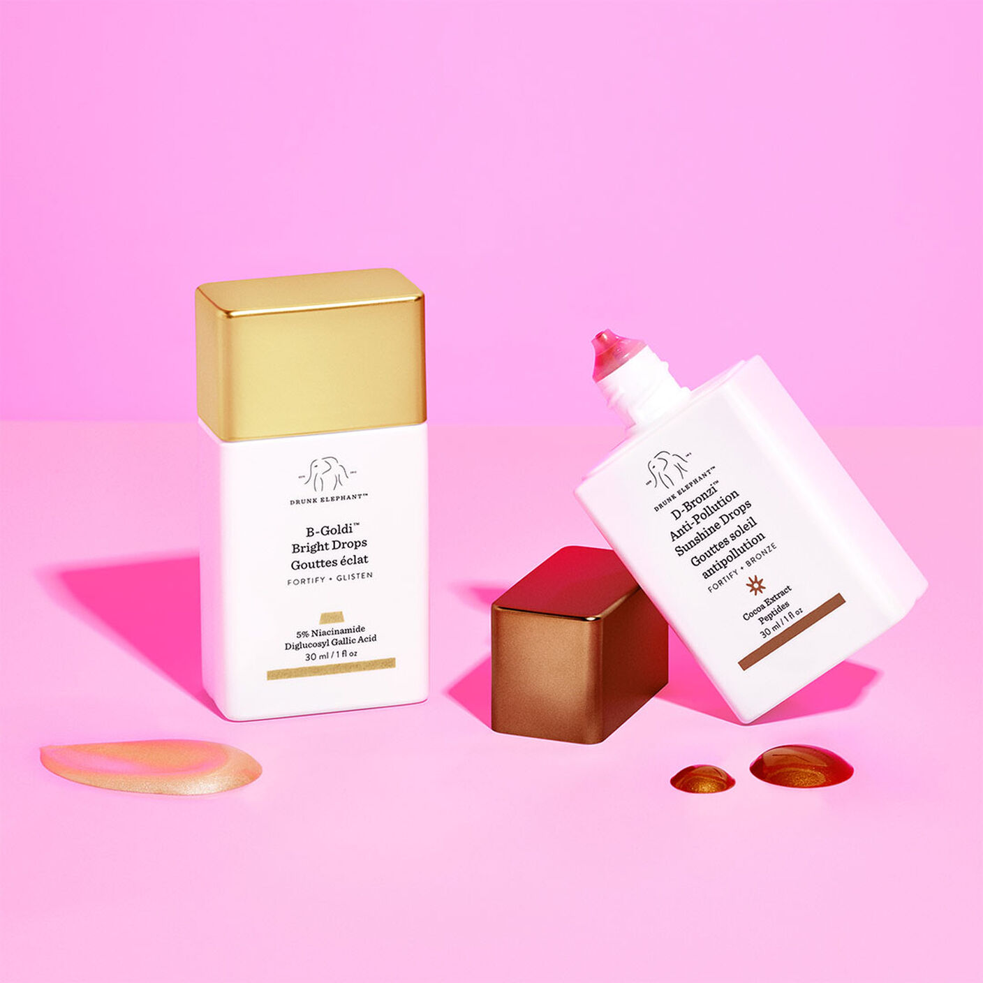 B-goldi with texture smear aside it with D-Bronzi with the cap off with drops of the serum aside it. 