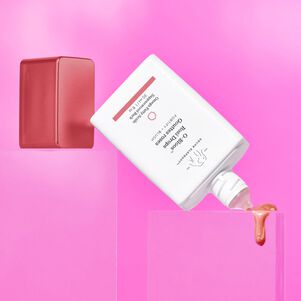 photo of O-Bloos at a downward angle with goop coming out, dripping onto a pink block