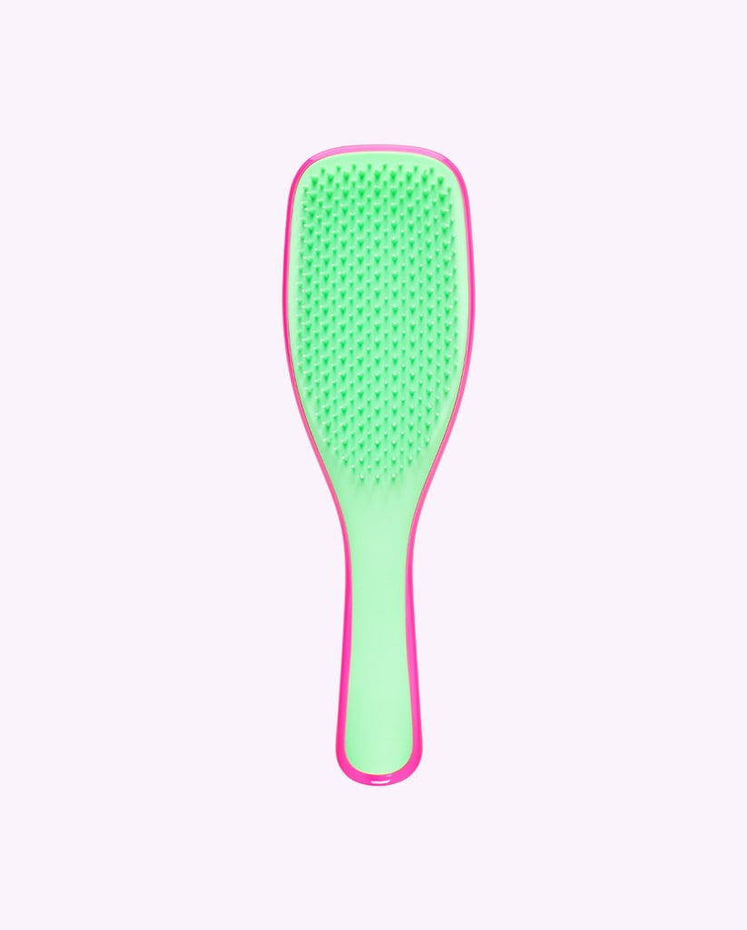 Drunk Elephant Tangle Teezer    Green and pink Tangle Teezer facing front.